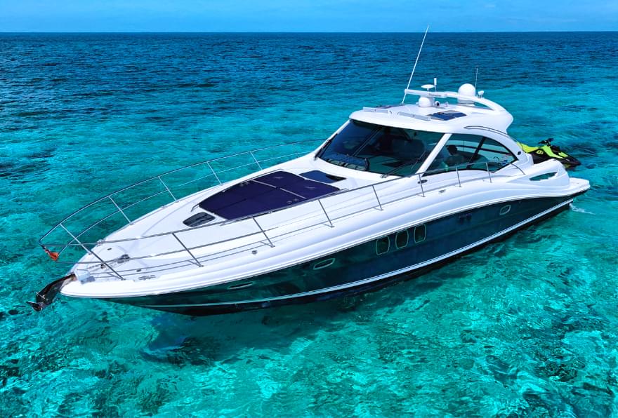 Sea Ray 480 Sundancer anchored in crystal-clear waters, perfect for a Grand Cayman yacht experience