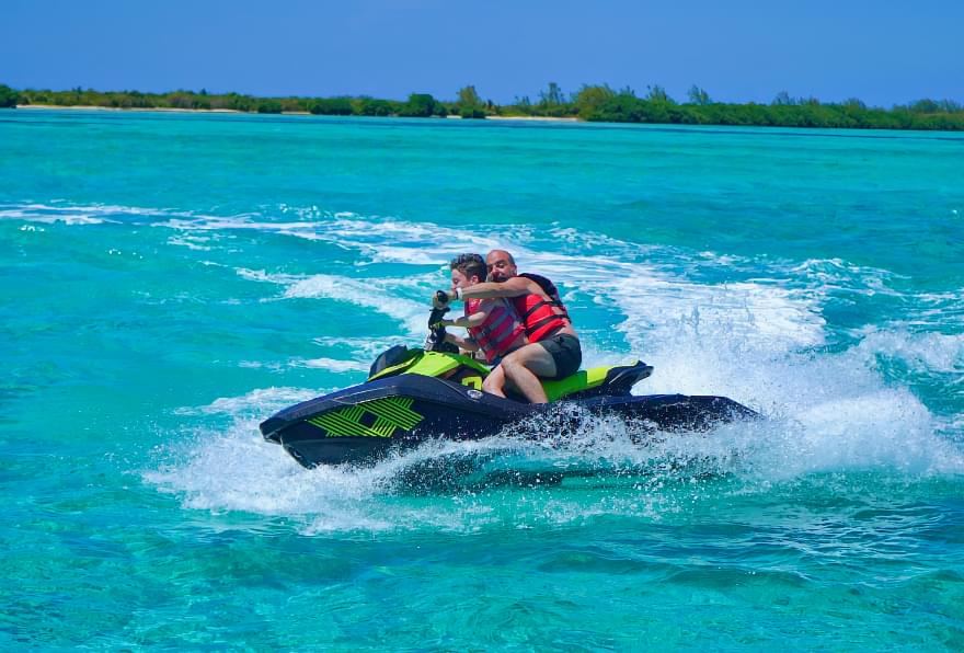 Jet ski racing across turquoise waters, offering thrilling activities with Cayman luxury sea tours