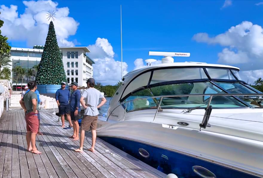 Guests boarding a luxury yacht at the dock, highlighting ease of yacht rental in the Cayman Islands