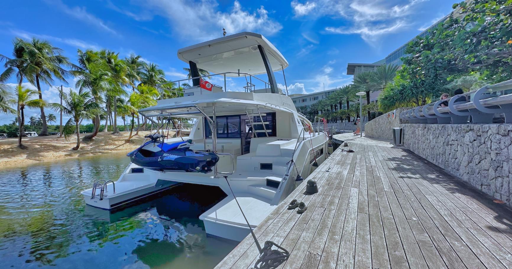 Luxury yacht moored in Camana Bay, showcasing the beauty of a yacht charter in Grand Cayman