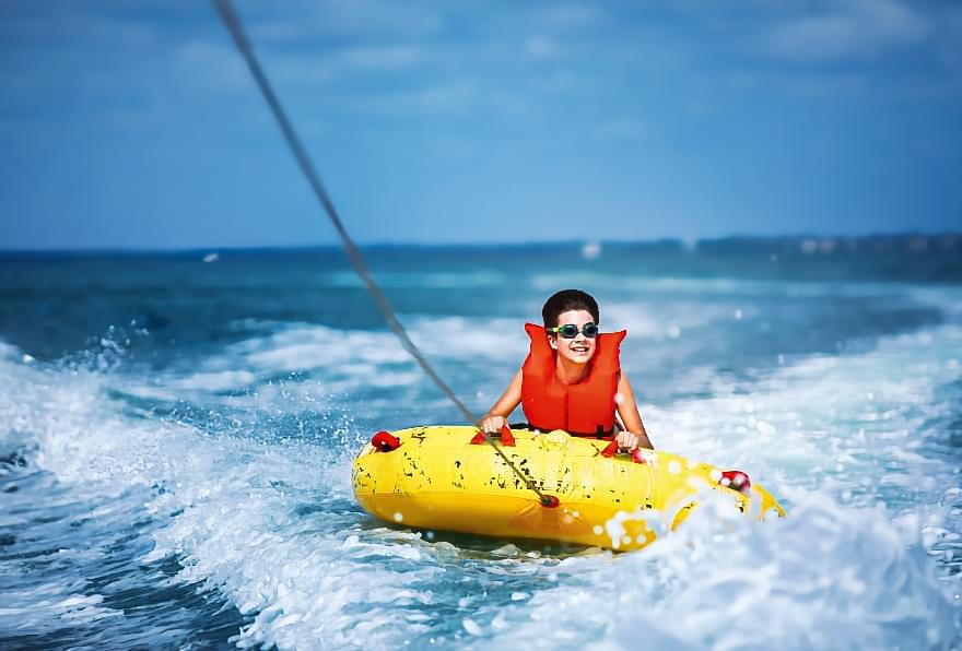 Child tubing on clear waters, following safety protocols for family fun