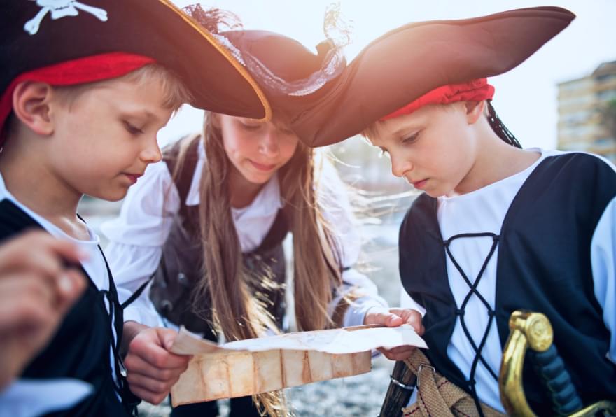 Kids in pirate costumes, engaging in safe and fun-themed boat activities