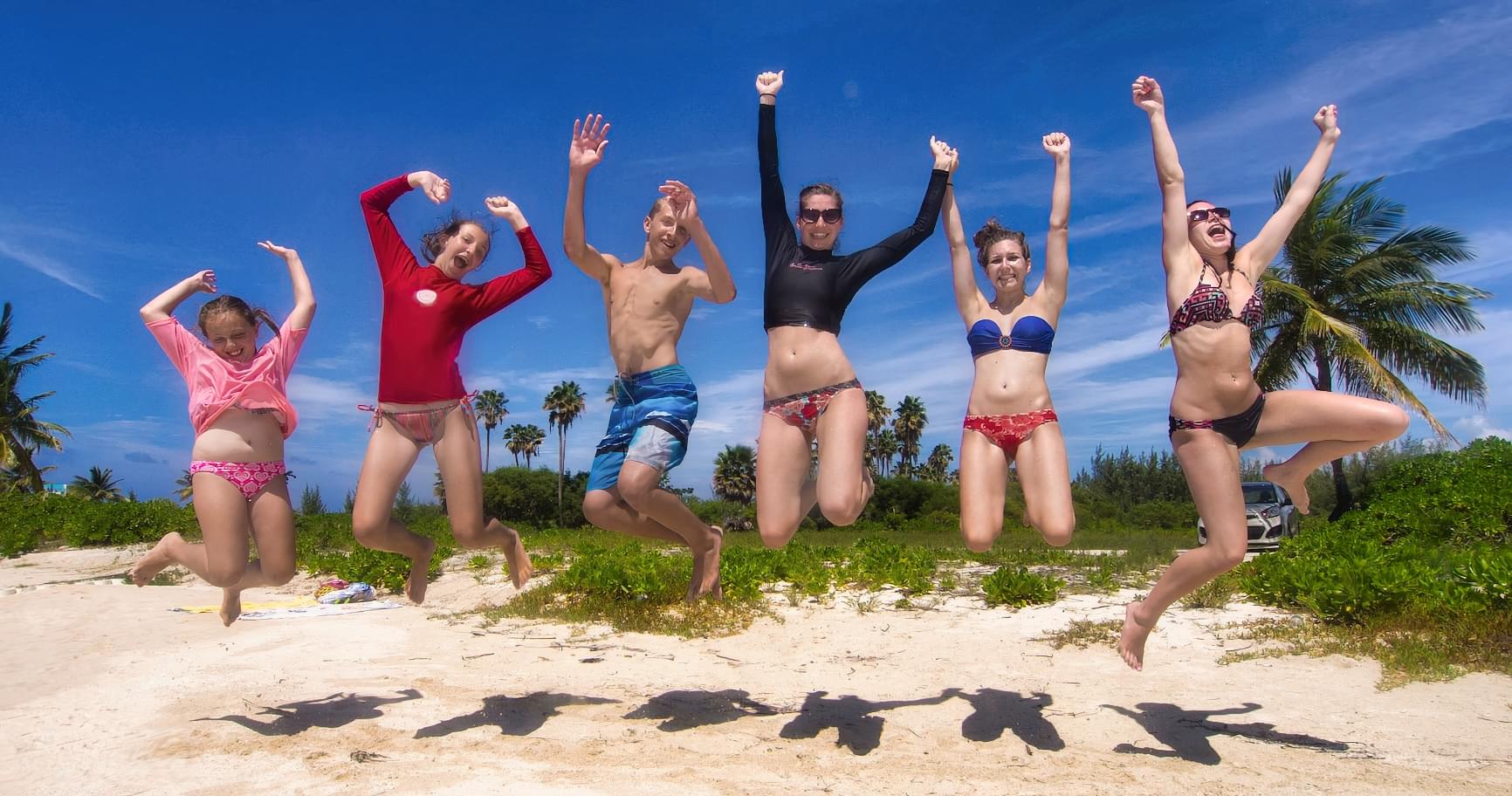 A group of friends is celebrating on a beach in Grand Cayman and enjoying a sunny day