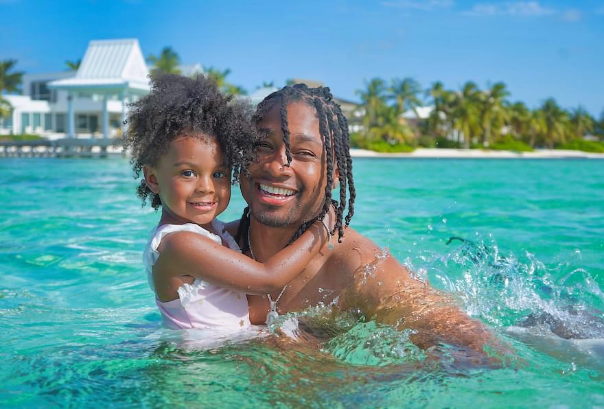 Father and daughter enjoying the turquoise waters, highlighting boats for hire Grand Cayman