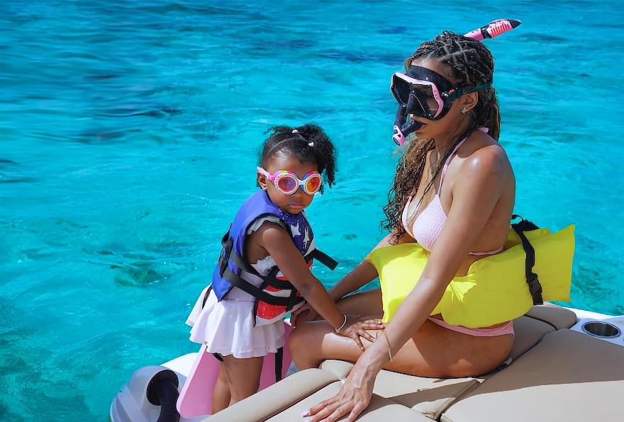 Family preparing to snorkel in the clear waters, highlighting the flexibility of boat rental Cayman