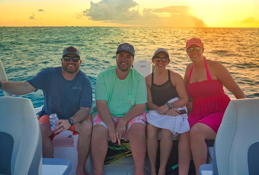 Group enjoying a sunset cruise in Grand Cayman, highlighting relaxation and stunning views