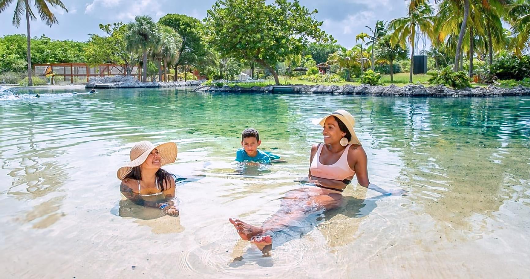 Families relaxing in shallow pools, enjoying a family-friendly activity.