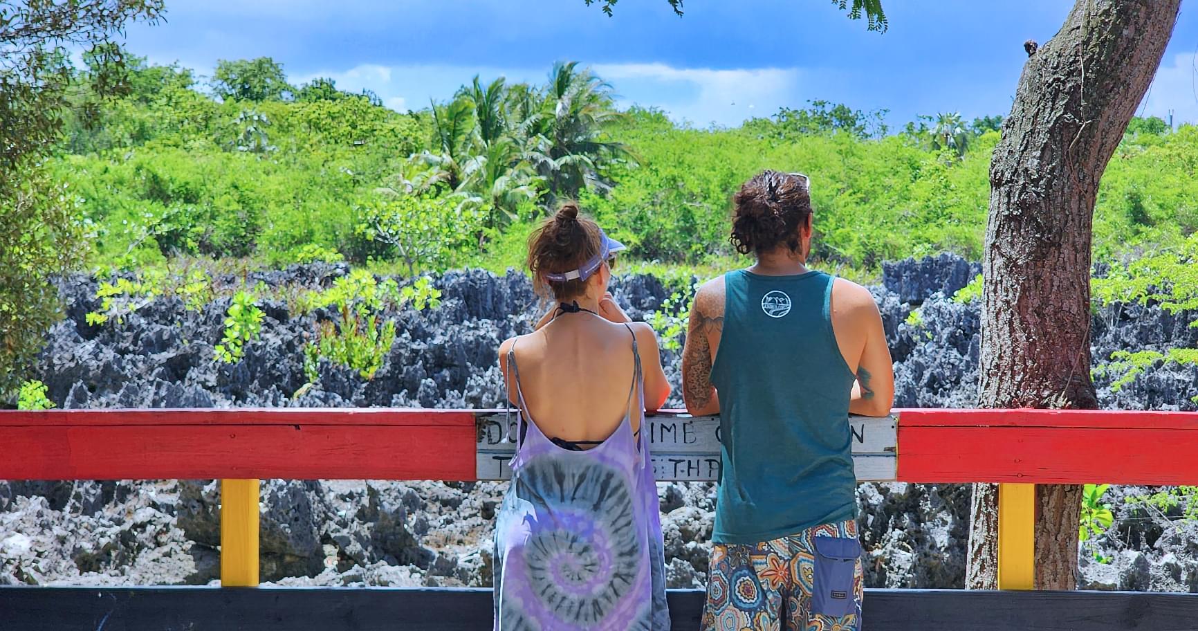 Couple admiring the rugged landscape at a viewing platform in Cayman Islands Hell