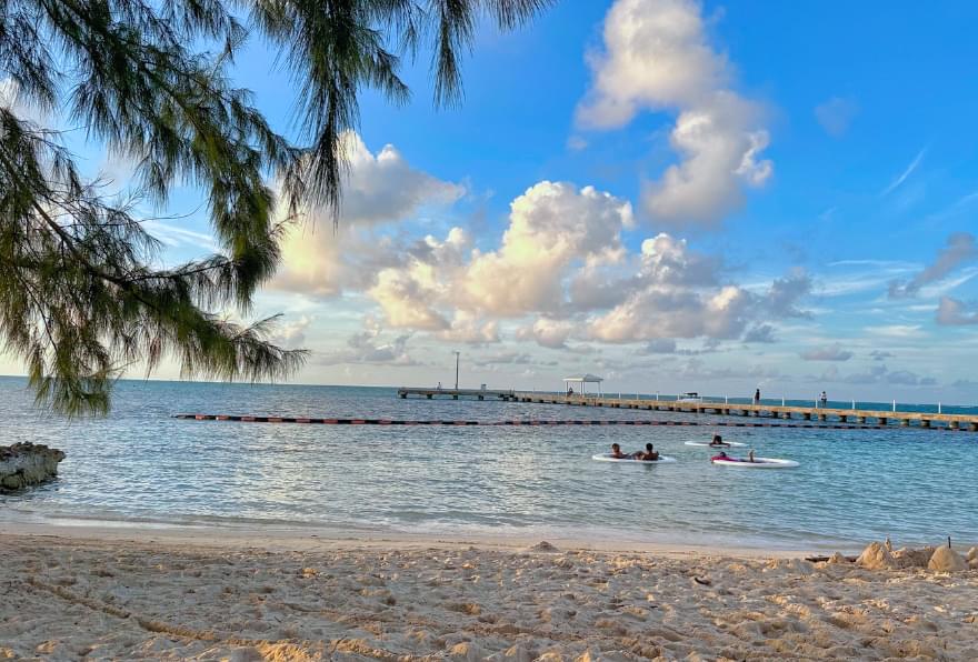 Crystal-clear shoreline and shallow waters at Rum Point Cayman, perfect for wading and relaxation