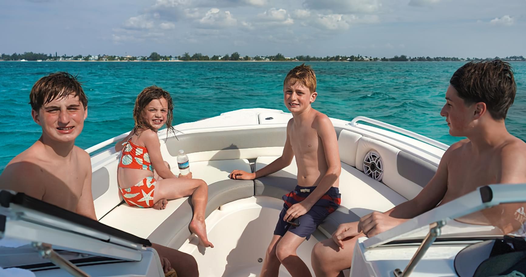 Kids enjoying a boat trip near Rum Point Beach, showcasing a family-friendly activity
