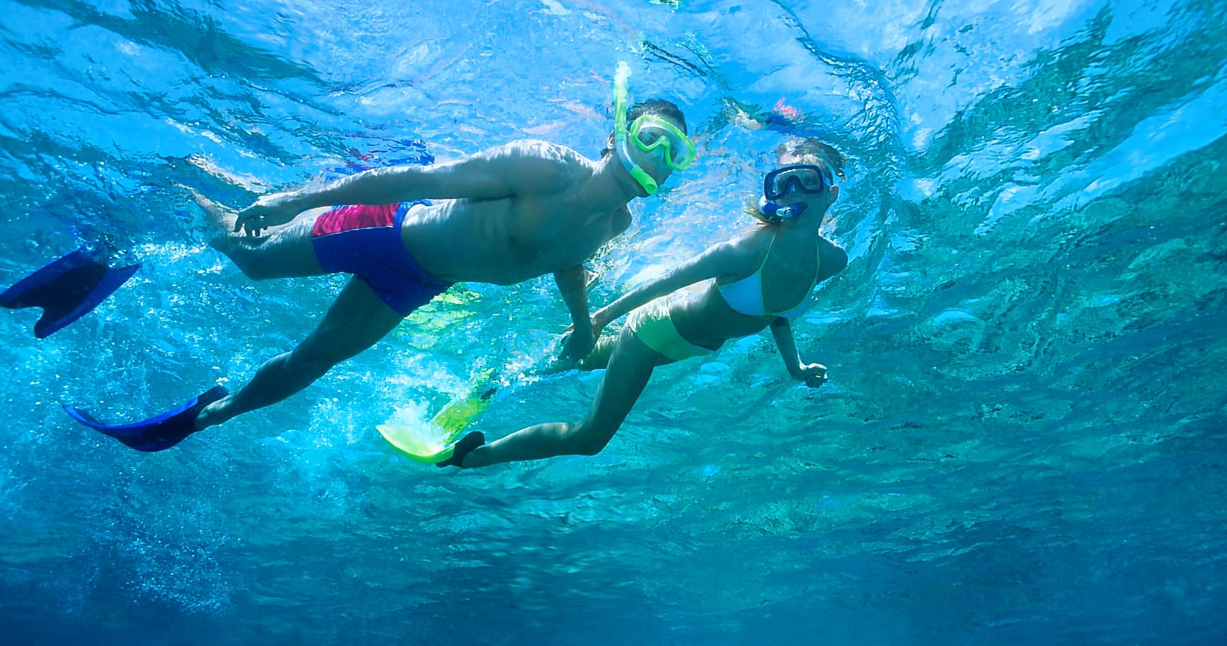 Snorkeler buddy pair swimming together highlighting teamwork in snorkeling