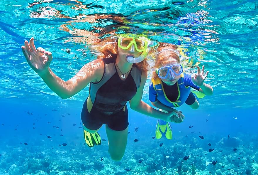 Snorkeler giving a thumbs-up, promoting confidence in a safe snorkeling experience