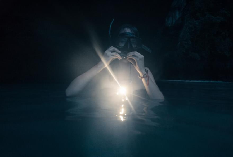 Nighttime snorkeling with bioluminescent waters showing unique snorkeling precautions for night adventures