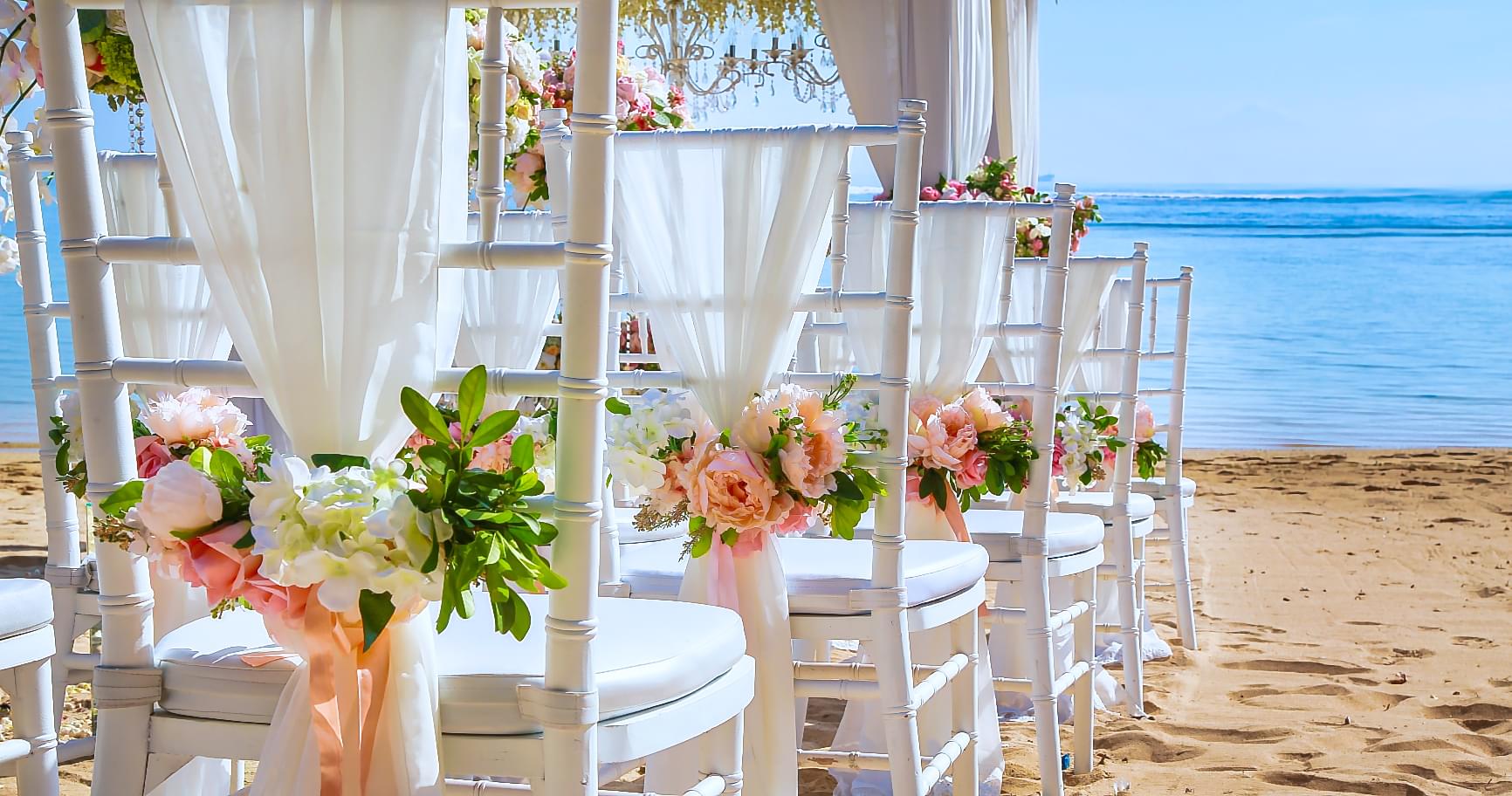 Scenic beachfront ceremony setup highlighting the natural beauty of a romantic island wedding