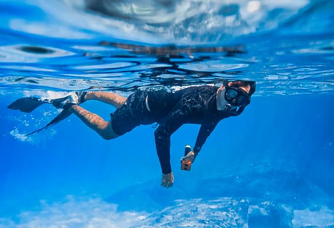 Snorkeler exploring underwater life in crystal-clear waters