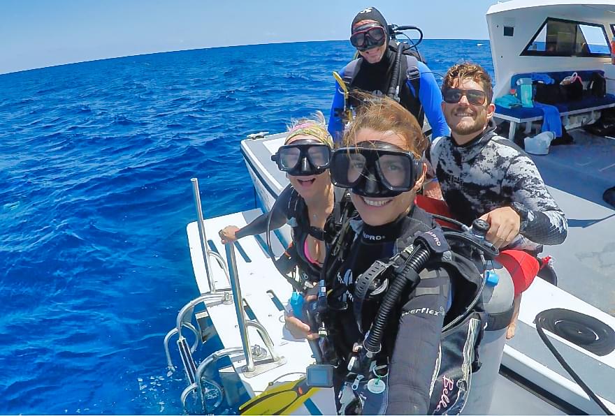 Divers preparing to explore ocean depths, experiencing steady sea temperature Grand Cayman
