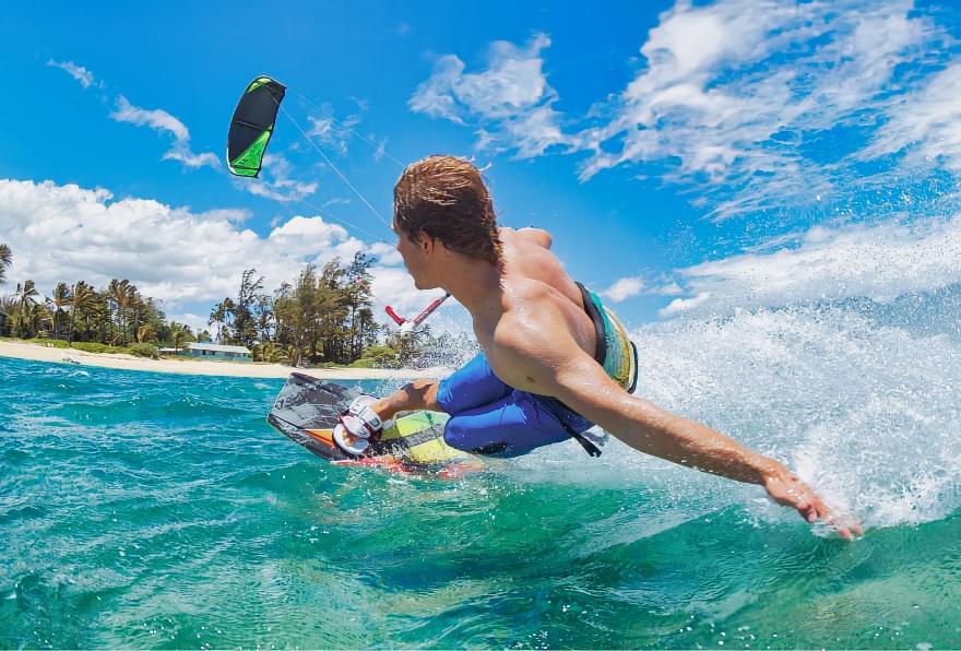 Kiteboarder gliding on calm waters influenced by Grand Cayman ocean temperature