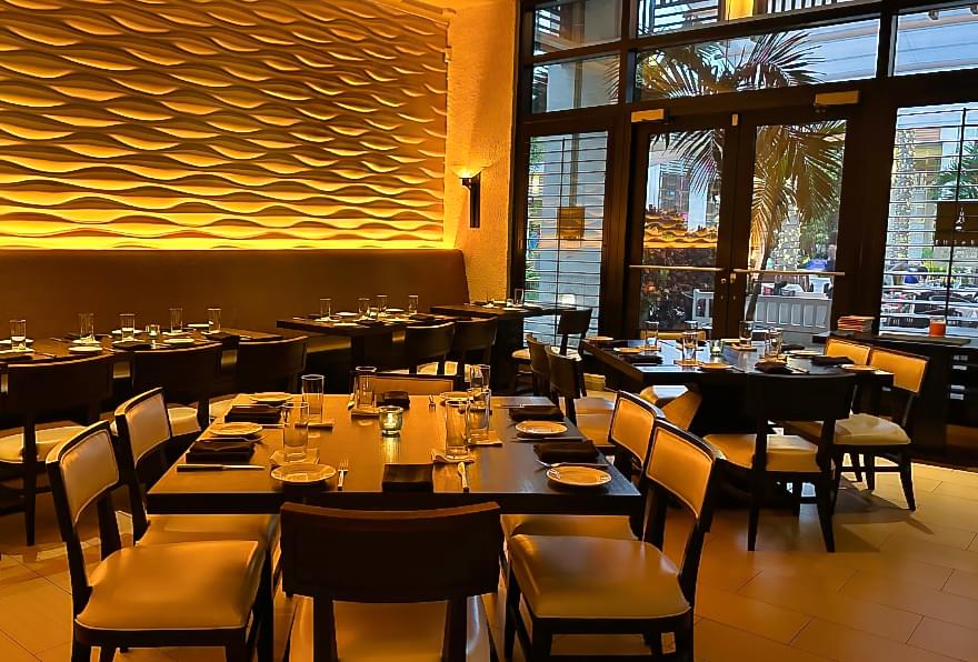 Dining area at Abacus restaurant in Camana Bay Grand Cayman, offering upscale seafood and farm-to-table dishes.