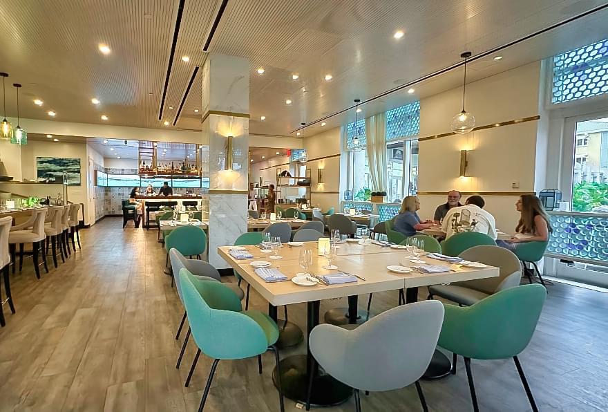 Dining area at Agua restaurant in Camana Bay Grand Cayman, specializing in Peruvian-inspired seafood dishes.