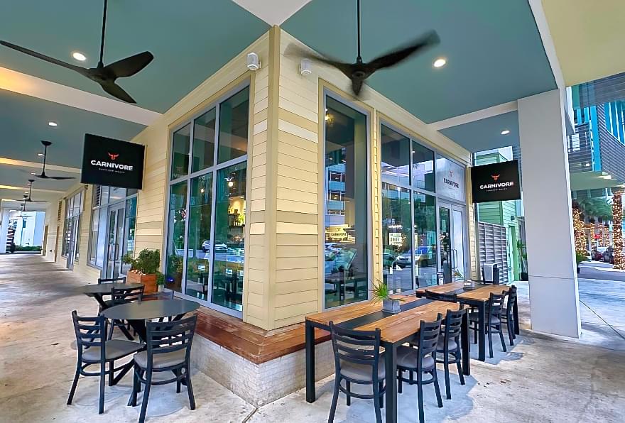 Carnivore restaurant at Camana Bay, specializing in premium meats and open-kitchen dining.