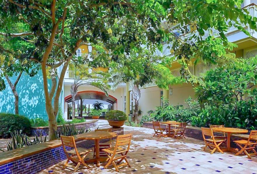 Tropical courtyard in Camana Bay, a peaceful retreat surrounded by greenery