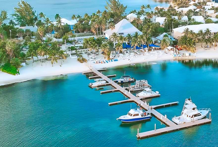 Aerial view of Kaibo Dock featuring boats and white sandy beach in Grand Cayman