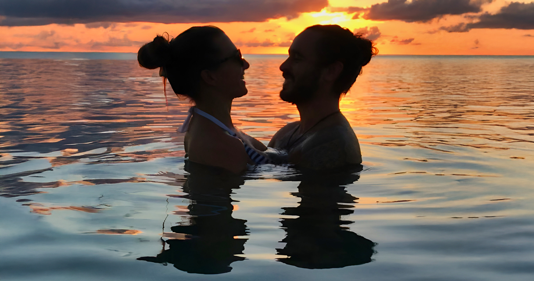 Couple enjoying a sunset in Grand Cayman, showcasing romantic things to do in Grand Cayman.