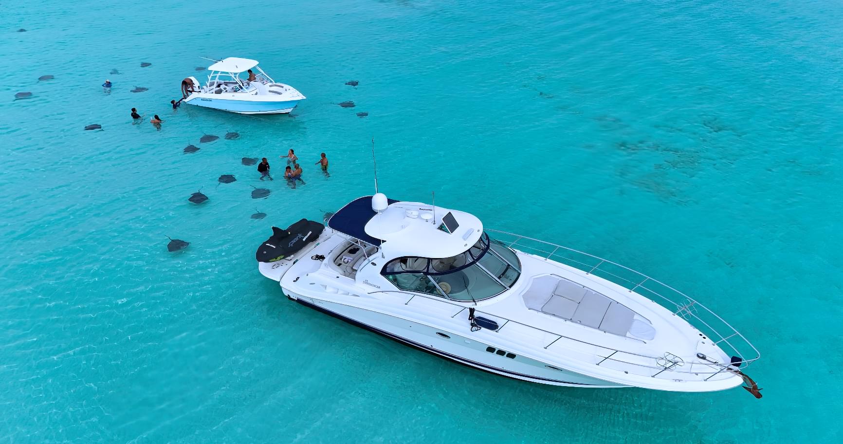 Luxury boats anchored, perfect for stingray city tours in Grand Cayman, combining relaxation and adventure