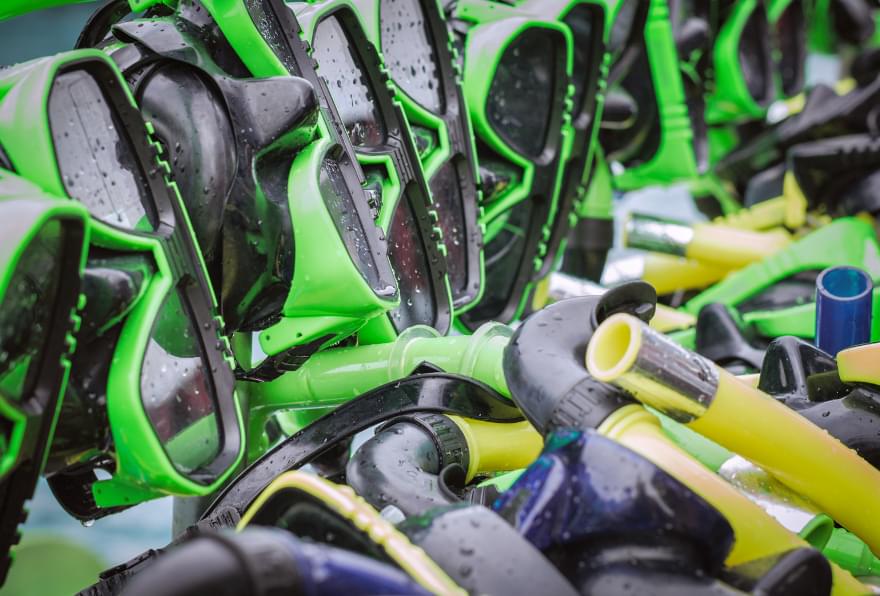 snorkeling gear prepared for a night water experience by the shore