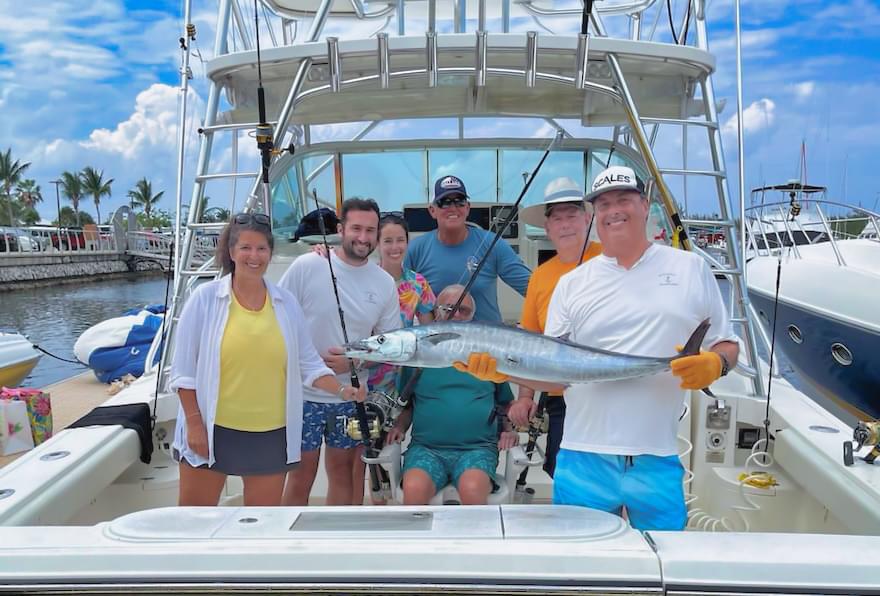 group of anglers showing wahoo caught on a fishing trip